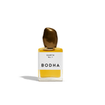 Bodha perfume bottle with gold cap and yellow liquid on white background