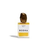 Bodha perfume bottle with gold cap and yellow liquid on white background