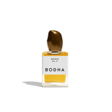 Bodha perfume bottle with gold cap and yellow liquid on white background