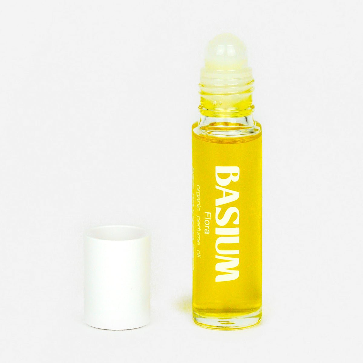 Basium Flora organic perfume oil in a clear roll-on bottle with white cap