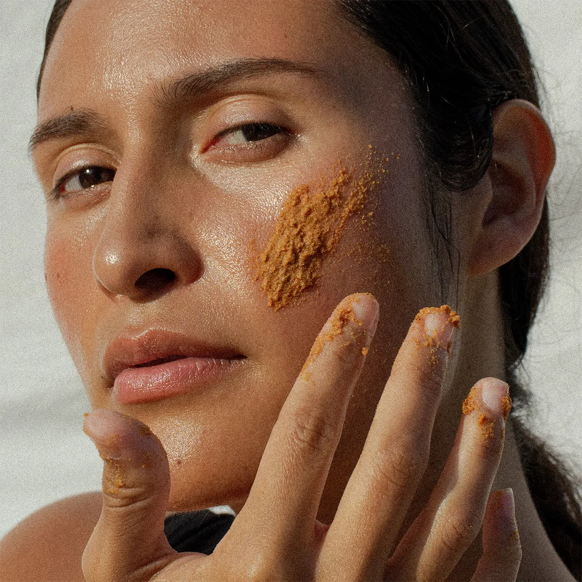 noto resurface face and body scrub in use